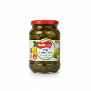 Jar of Bodrum Mini Cornichons with red lid, showing pickled small gherkins inside
