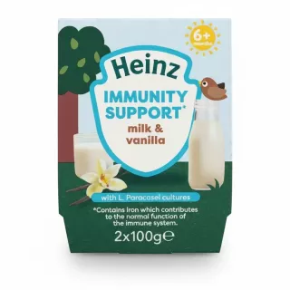 Heinz Immunity Support milk and vanilla 2 pack pots in hand showing front packaging