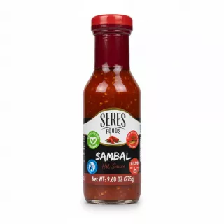 Bottle of Seres Foods Sambal Hot Sauce with red chili pieces in glass bottle