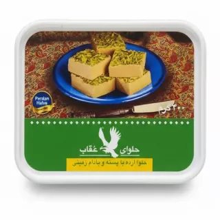 Oghab Persian tahini halva in white rectangular tub with pistachio topping