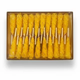 Pack of bright yellow saffron-infused rock candy sticks in transparent box