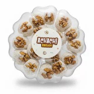 Achachi Basloch coconut sweets topped with whole walnuts in round plastic container