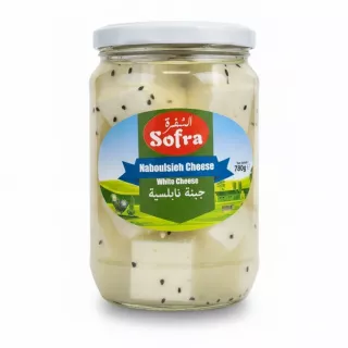 Jar of white Naboulsieh cheese with black seeds in brine