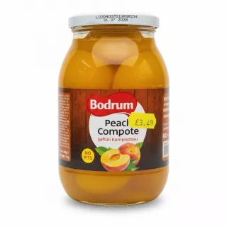 Jar of Bodrum Peach Compote with visible peach halves inside
