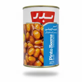 Can of Badr Pinto Beans in Tomato Sauce held in hand showing front label