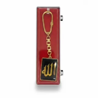 Gold-coloured keychain with Arabic calligraphy on black background in display box