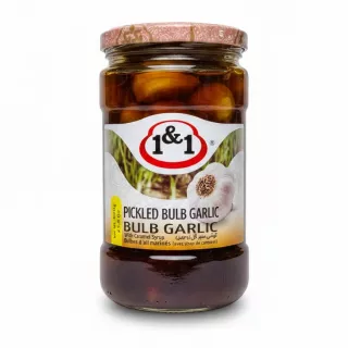 Jar of 1&1 Pickled Bulb Garlic with caramel syrup showing label