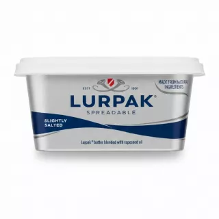 Lurpak Spreadable tub held in hand with label showing brand and product type