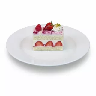 Single slice of rich berry delight cake with fresh strawberries and whipped cream on a white plate
