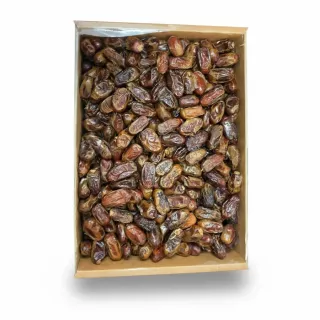 Close-up view of premium Aliat Taibah dates inside a cardboard box