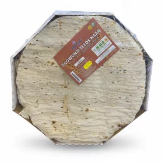 A stack of round flat breads with black seeds wrapped in plastic with a label