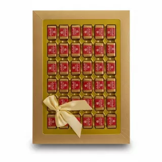 Gold box of individually wrapped Achaachi chocolates with satin bow