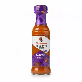 Bottle of Nando's Peri-Peri Garlic Medium Sauce with purple label