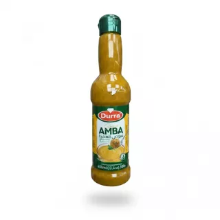 Bottle of Durra Amba sauce with green cap held in hand