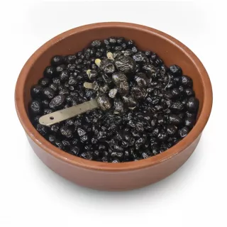 Close-up of shiny black olives in a brown container
