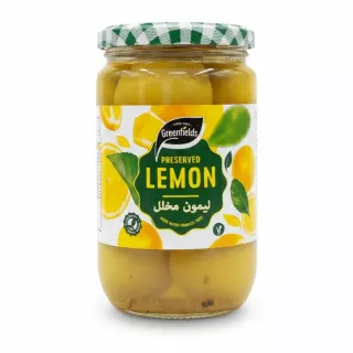 Jar of Greenfields preserved lemons with green and white checkered lid, showing whole preserved lemons in brine