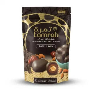 Enhanced Front of Tamrah dark chocolate date almond snack pack, black and gold pouch showing chocolate-coated date with almond centre