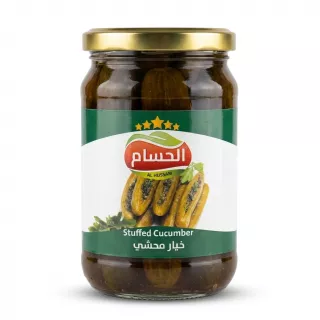 A professional front view studio shot of a glass jar of Al Hussam Stuffed Cucumber with a green and white label and a gold lid, centered on a plain white background with soft shadows.