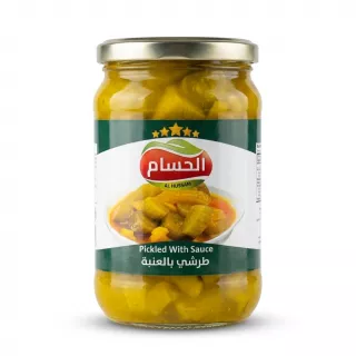 A 1:1 e-commerce photo of a glass jar containing Al Hussam Pickled With Sauce, isolated on a pure white background. The jar is centered and features a clear green and white label with the brand name 'Al Hussam' and five gold stars, an image of the pickled contents, and the product title in both English and Arabic.