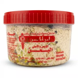 Enhanced Tub of Al Yaman Super Halawa Pistachio with red lid shown in hand