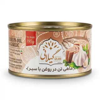 Enhanced Hand holding Gilani Tuna Fish in Oil with Garlic 180g tin in a grocery aisle