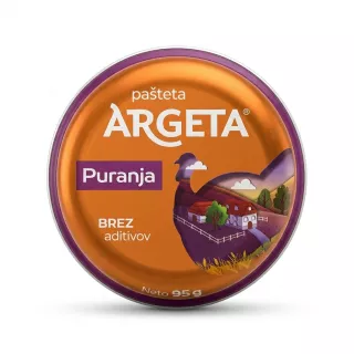 A professional studio photo of a single, round can of Argeta Turkey Pâté (Puranja) centered on a pure white background. The orange and purple packaging is in sharp focus, featuring the product name and a scenic farm illustration.