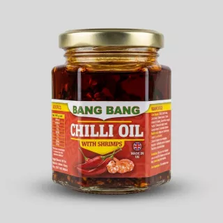 Enhanced Bang Bang Chilli Oil With Shrimps jar held in hand in grocery aisle