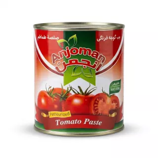An authentic front view of an 800g tin of Anjoman Pasteurized Tomato Paste with its detailed red, green, and white label. The label features the Anjoman brand name in English and Arabic, a vibrant graphic of fresh tomatoes, and the text "Tomato Paste Pasteurized". It is presented on a clean white background with professional lighting and soft, even shadows.