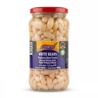 A 580g glass jar of Aycan white beans, featuring a red lid and clear glass. The blue label displays "Aycan," "WHITE BEANS," and translations in several languages, set against a seamless white background with a soft shadow.