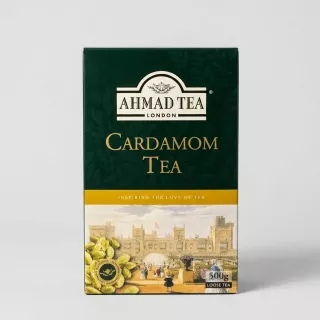 Enhanced Hand holding Ahmad Tea Cardamom Tea 500g box in front of tea shelf