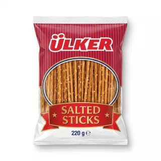 A 220g pack of Ülker Salted Sticks snack is shown in a professional, front-facing e-commerce photo with clean, even lighting and a soft shadow on both sides. The red and blue packaging features the distinct Ülker logo and a clear window displaying the salted pretzel sticks inside.
