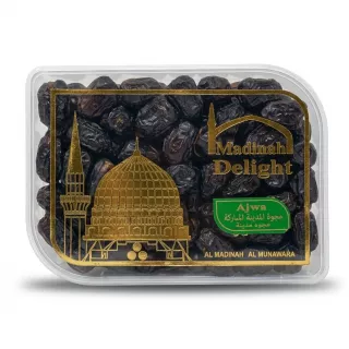 A 1:1 professional e-commerce product photograph of a clear plastic tub filled with premium Ajwa dates from Madinah Delight. The product is perfectly centered and fills 85% of the frame against a clean, white background, lit by soft, even studio lighting that creates subtle, symmetrical shadows. The detailed golden foil artwork, featuring a mosque and minaret, and the product text in English and Arabic are sharp and clear, with all price stickers and background elements removed.