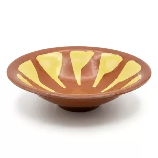 Enhanced Hand holding a decorative brown and yellow ceramic shallow bowl, side view