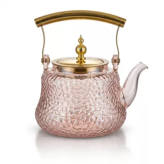 Enhanced Glass teapot with gold handle and lid on countertop