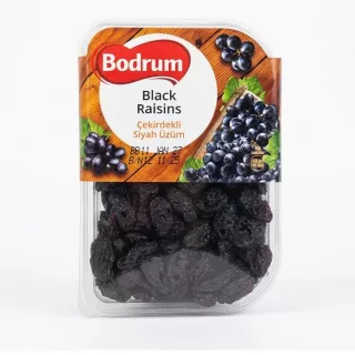 Hand holding a 250g pack of Bodrum Black Raisins with label visible