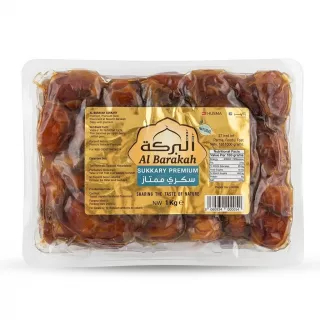Front view of Al Barakah Sukkary Premium Dates 1kg pack held in hand showing the gold packaging and price label