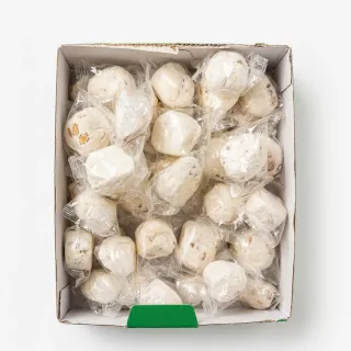 Individually wrapped white nougat candies in a box