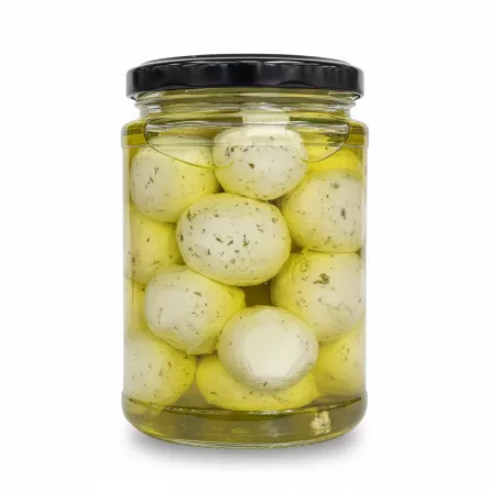 Close-up of Labneh balls immersed in olive oil with mint