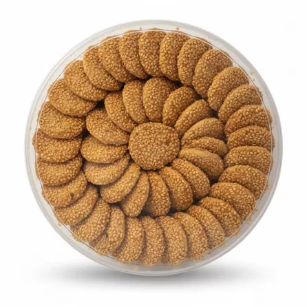 Round transparent tray filled with sesame seed coated Barazek Shamiya cookies
