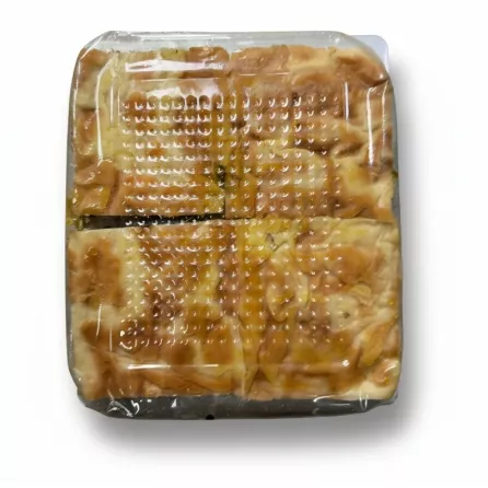 Close-up of spinach pastry boregi slices in a plastic container