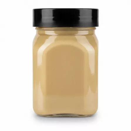 Jar of Devinjax Tahini showing thick creamy sesame paste in transparent container with black lid