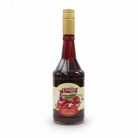 Bottle of Chtoura Fields Grenadine Syrup with gold cap and pomegranate label