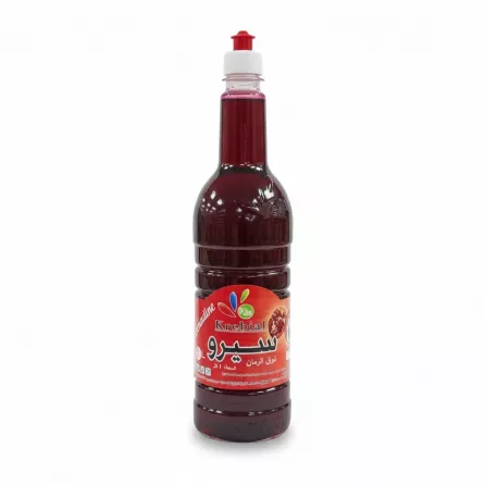Full bottle of Krebial Algerian pomegranate syrup with red label and easy pour cap