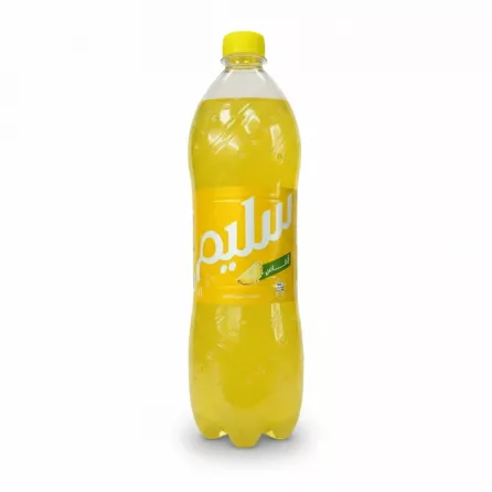 Slim pineapple flavoured soda bottle with Arabic branding held in hand in store
