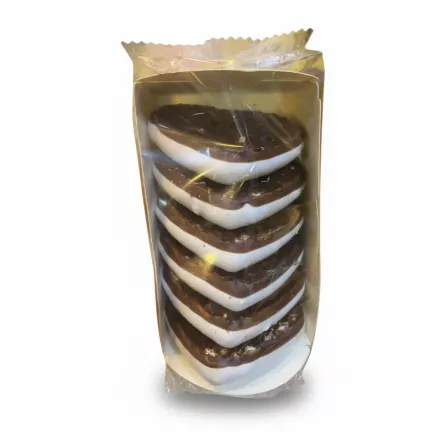 Close-up of heart-shaped gingerbread biscuits topped with chocolate and white icing in a clear box on a white background