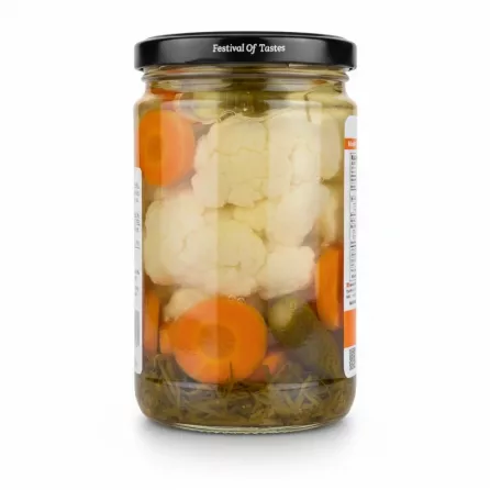 Side view of Badr mixed vegetables jar showing vegetables in brine