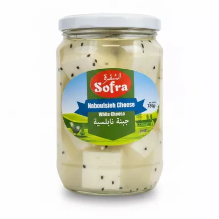 Jar of white Naboulsieh cheese with black seeds in brine
