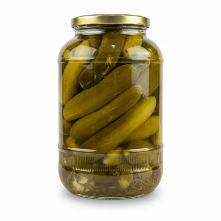 Close-up side view of pickled cucumbers in glass jar