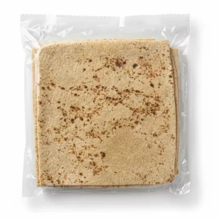 Close-up of a single brown-speckled Lebanese Lavash Markouk wrap in plastic packaging