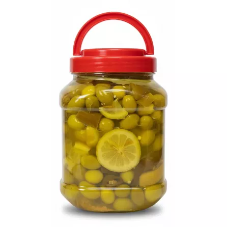 Close-up of pickled green olives in brine with lemon slices in jar
